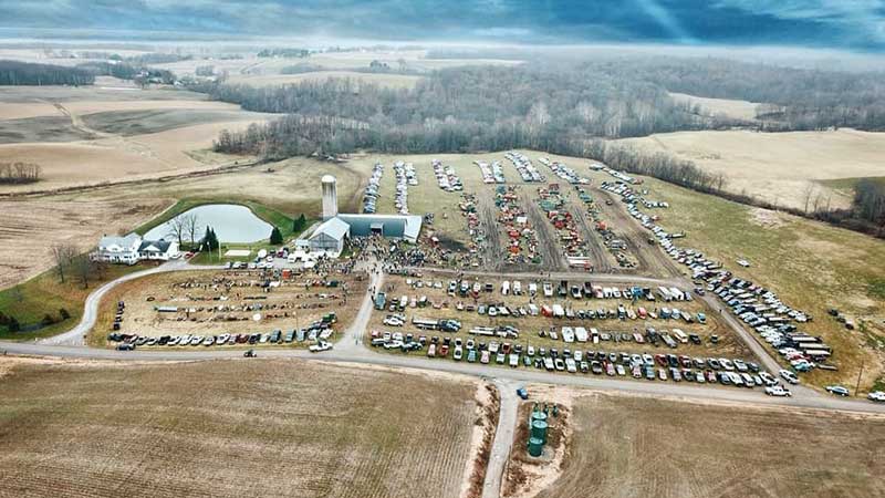  Tractors, combines and other farm equipment line the field in preparation for KIKO's annual New Year's Auction. 